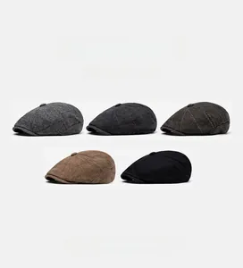 Flat lay display of vintage wool blend flat caps in various plaid patterns and solid black