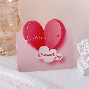 Pink 3D heart Valentine's Day card with artistic Love text on textured background