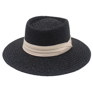 Detailed weave texture of a French style flat top straw hat with beige ribbon trim
