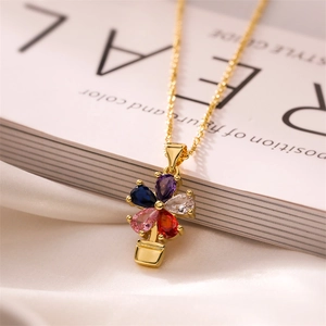 Detailed close-up of gold flower pot necklace with vibrant colorful teardrop crystals