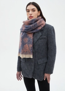Detail showing blue and pink plaid wool scarf with beige fringe on a grey suit jacket