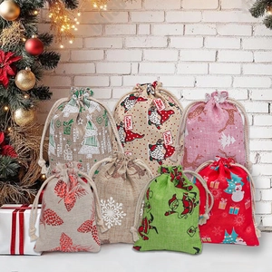 Christmas burlap drawstring gift bags with gnome and reindeer patterns on festive background
