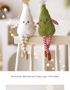 Detail of plush Christmas tree dolls with striped long legs sitting on a white chair