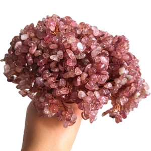 Handmade pink crystal fortune tree woven with copper wire on a clean white background