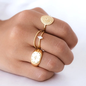 Set of four 18k gold plated brass rings featuring star signet and beaded textures