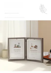 Detail of grey textured double folding photo frame with calendar insert and home decor