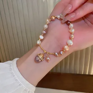 French vintage freshwater pearl bracelet with a golden cat charm and zircon accents