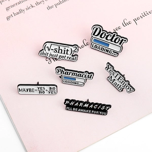 Set of creative math and pharmacy enamel pins on a pink book background