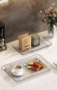 Macro shot of thick-edged clear acrylic tray set on marble table for luxury home decor