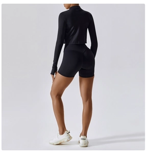 Close-up of black yoga set showing seamless high waist shorts and thumb-hole sleeves