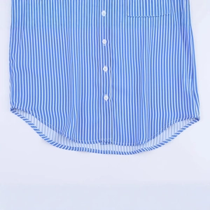 Relaxed blue and white vertical striped cotton shirt with a curved hem and buttoned front