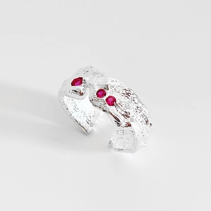 Minimalist 925 sterling silver open ring with irregular lava texture and red zircons