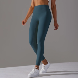 Close-up of high-waisted dark teal yoga pants with seamless stretch and body-contouring fit