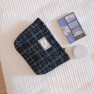 Blue and black tweed fabric clutch bag with Time to Party patch on white quilted background