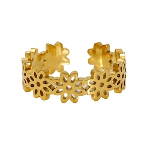 Detail of gold plated stainless steel ring with hollow daisy flowers and a polished finish