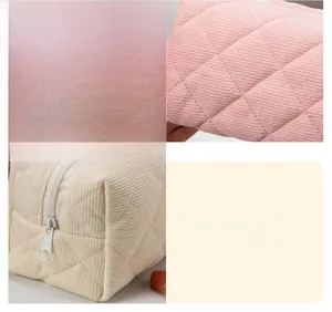 Detailed view of diamond quilted corduroy fabric with precise stitching on large makeup bags