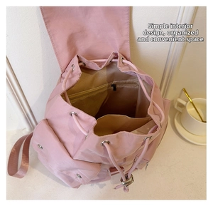 Pink nylon backpack detail showing spacious main compartment with interior pockets