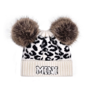 Close-up of baby leopard print knit hat with brown faux fur pom-poms and MINI embroidery