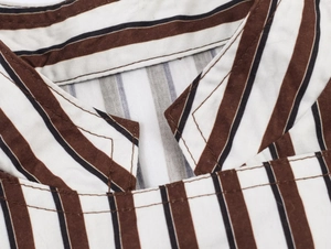 Close-up of classic striped collar with high-quality stitching on cotton fabric