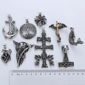 Detailed comparison of nine gothic titanium steel pendants with size ruler reference