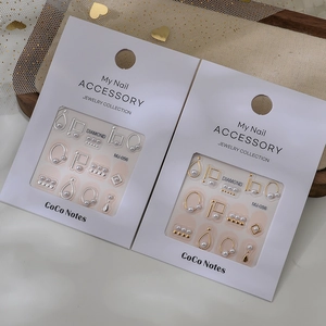 DIY nail art jewelry kit with pearls, gold metal frames, and charms for 3D manicure decor