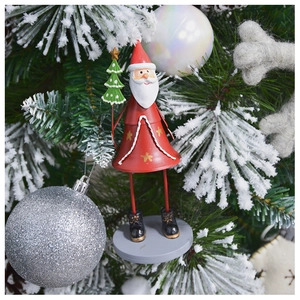 Détail d'un ornement de cloche en métal peint Père Noël suspendu à un sapin de Noël