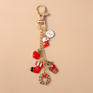 Detail of Christmas keychain with enamel reindeer, stockings, and gold lobster clasp