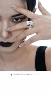 Detailed view of 925 sterling silver wide band ring with folded texture on index finger
