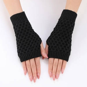 Black knit fingerless gloves with hollow pineapple pattern and ribbed cuffs on white back