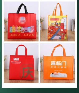 Detail of four colorful non-woven tote bags with custom logo printing for Christmas gifts