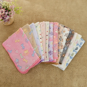 Detailed close-up of colorful flannel pet blankets with bone and paw prints patterns