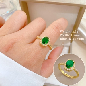 Detailed view of adjustable gold ring with green sapphire and side white diamonds