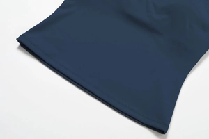 Detail shot of the navy blue yoga top hem featuring precise double-needle stitching