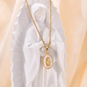 Detail of golden oval Virgin Mary pendant with mother of pearl inlay on silk