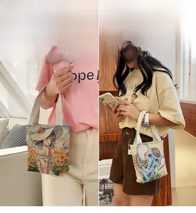 Detailed close-up of small embroidered canvas tote bags with vintage floral and elephant patterns