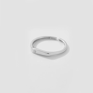 Close-up of S925 sterling silver ring hallmark and small zircon inlay on a white base