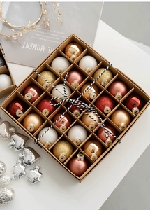 Close-up of 25 assorted Christmas glass ornaments in a gift box with glitter finishes