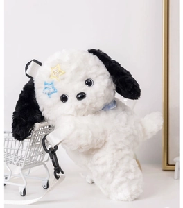 Detailed view of plush panda dog bag with yellow star hairpins and blue bow tie strap
