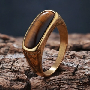 Detailed macro view of gold vintage ring with tigers eye stone on rustic wood