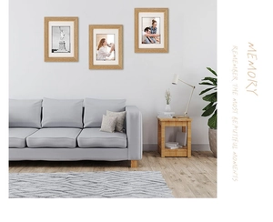 Three-piece solid wood photo frame set displayed on a minimalist living room wall