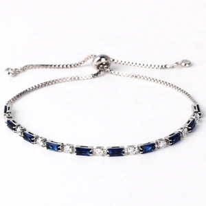 Detail of silver chain bracelet with blue rectangular gems and adjustable slide clasp