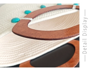 Detailed macro view of woven tote with wooden D-handle and turquoise stone accents