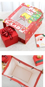 Detail view of red Christmas gift bag with transparent window, ribbon box and greeting card