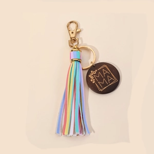 Detail of wooden MAMA pendant keychain with colorful tassel and gold ring clip