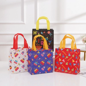 Set of 4 colorful non-woven birthday gift bags with cartoon patterns and festive handles