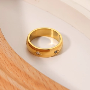 Minimalist gold titanium steel star ring with diamond inlay on a clean white background