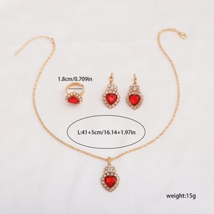 Macro detail of red heart gemstone necklace and earring set with diamond accents