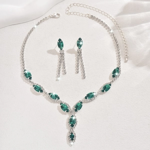 Detailed view of silver bridal set with emerald marquise rhinestones and drop tassel earrings