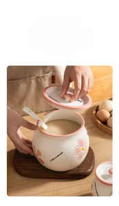 Detail of hand lifting a ceramic seasoning jar lid with flower pattern and spoon slot