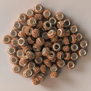 Macro shot of 7x12mm peach rhinestone beads with large silver-tone metal holes for jewelry